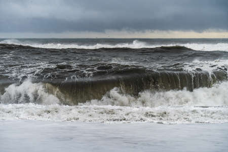 Stormy waves at black volcanic beach near famous Reynisfjara rocks at south coast of Icelandの写真素材