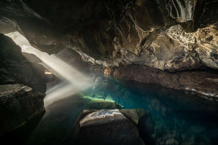 Grjotagja volcanic cave with an incredibly blue and hot thermal water near lake Myvatn. The geothermal grotto and cave, areas of Icelandの写真素材