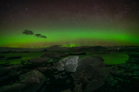 Incredible Aurora Borealis activity above the coast in Icelandの写真素材