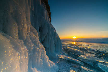 View from the grotto during sunset on the frozen Lake Baikalの写真素材