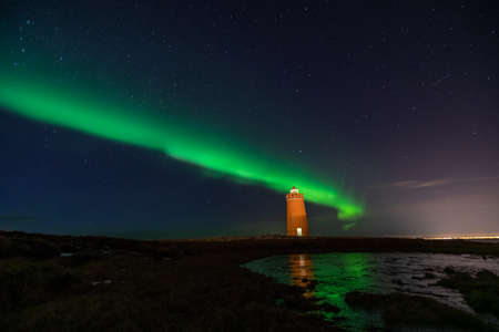 Lighthouse on Reykjanes peninsula under nortern lights. Iceland. Timelapseの写真素材