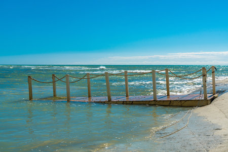 Serene Coastal Pier in Sicily, Italy Under Clear Blue Skiesの写真素材