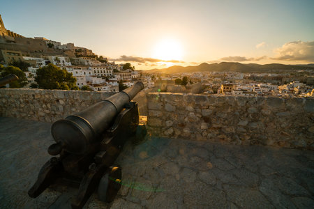 Historical Cannon at Sunset Overlooking Ibiza Townの写真素材
