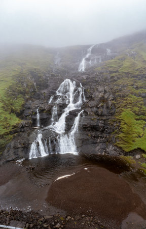 Stunning Aerial View of Waterfall in Faroe Islands during Late Summerの写真素材
