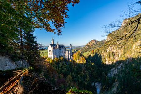 Enchanting Neuschwanstein Castle Surrounded by Autumn Foliageの写真素材