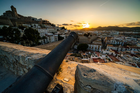 Historical Sunset View Over Ibiza Old Town with a Cannonの写真素材
