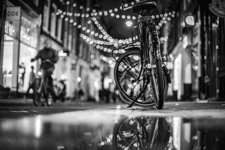 Charming Amsterdam Street - Bicycles and Reflections at Nightの写真素材