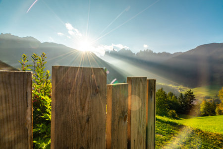 Breathtaking Sunrise Over the Alps in Italy with Wooden Fenceの写真素材
