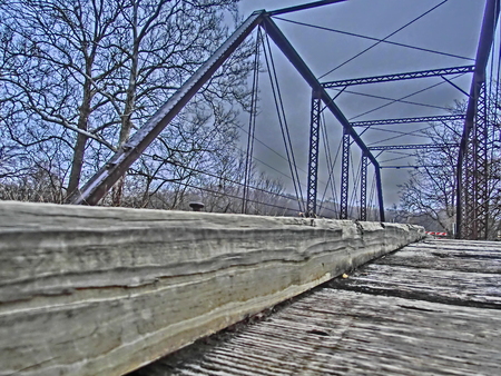 Wooden boards of a old bridge crossing a small creek.の写真素材