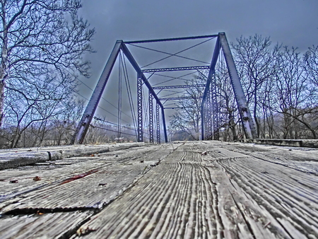 Wooden boards of a old bridge crossing a small creek.の写真素材