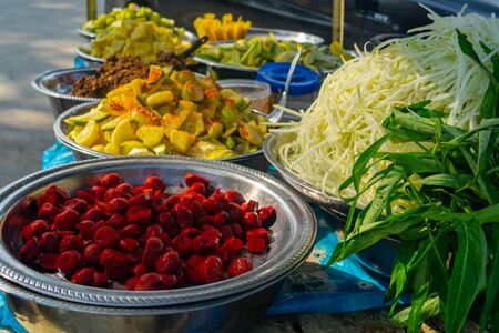Bowls of brightly coloured tropical fruit on a street cart in Mandalay, Myanmarの写真素材
