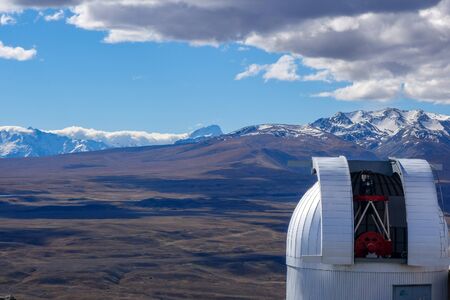White dome of a telescope at Mt John University Observatory, overlooking Lake Tekapo in the mountains of New Zealand's South Islandの写真素材