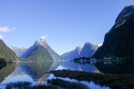 Calm waters and dramatic peaks of Milford Sound in the remote Fiordland region in the south west of New Zealand's South Islandの写真素材