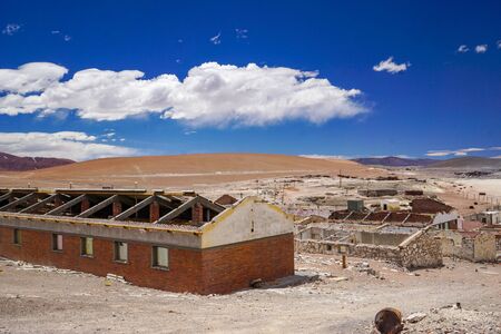 Abandoned buildings decay slowly in the abandoned mining settlement ghost town of Mina La Casualidad, in the high Andean puna desert of Salta province in Argentinaの写真素材