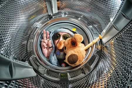 Hippie into a washing machine with glasses, flowers, peace symbol, dog and fluteの写真素材