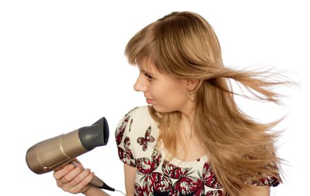 girl with hairdryer isolated on whiteの写真素材