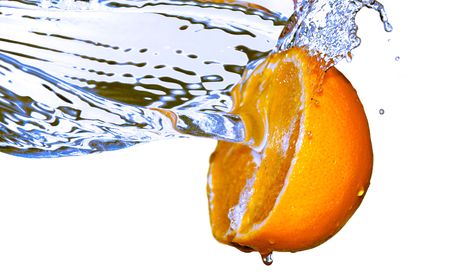 photo of water splash on half of orangeの写真素材