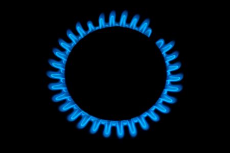 kitchen gas burning with blue flame isolated on black backgroundの写真素材