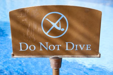 do not dive sign with blue water in backgroundの写真素材