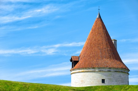 Kuressaare castle tower with blue sky in background and green grass in foreground (Saarema, Estonia)の写真素材