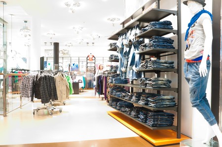 interior of the modern clothes shop. Image overexposed by intent, all customers blured interior of the modern clothes shop. Image overexposed by intent, all customers blured