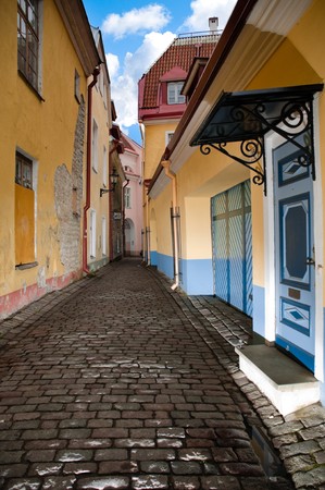 narrow cosy street in center of old european town. Blue cloudy sky in background. Tallin, Estonia, Europe.の写真素材