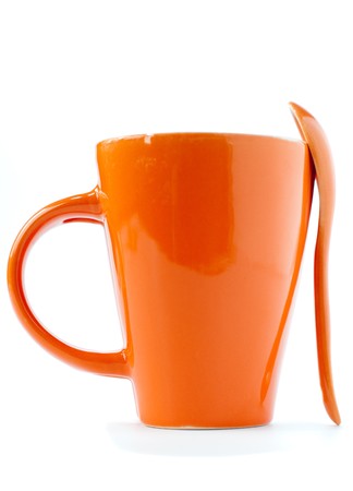 orange empty ceramic cup and spoon isolated on whiteの写真素材