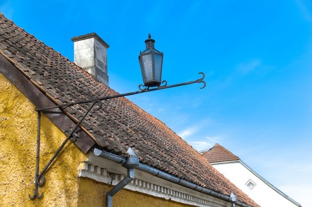 beautiful old roof top with downtake tubes and lantern with blue cloudy sky in backgroundの写真素材