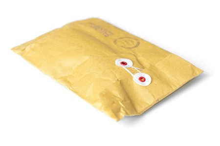 closed yellow mail parcel isolated on white background