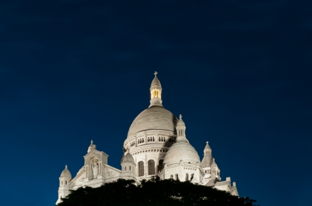 Night view of Basilica of the Sacred Heart of Paris with deep blue sky (Paris, France, Europe).の写真素材
