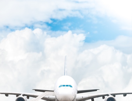 White jumbo air plane at airport ready for boarding. Blue cloudy sky in background.の写真素材