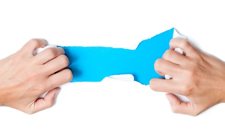 paper torn by woman hands, place for copy under torn paper, isolated on white backgroundの写真素材