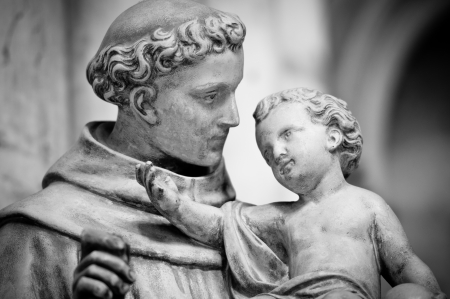 Statue of man holding small boy on his hands. Sculpture from Saint Denis cathedral. Paris, France, Europe.の写真素材