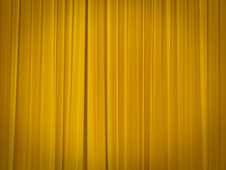 stage of the theatre with yellow curtains closedの写真素材