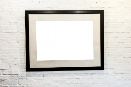 Square black frame with blank space inside on white brick wall  Gallery or house interior  Presentation or exhibition of photos, pictures and illustrations の写真素材