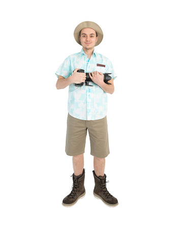 Happy man tourist in blue shirt brown shorts and hat with dslr camera. Traveler going to photo tour. Isolated on white background. Interesting trip on summer vacation.の写真素材