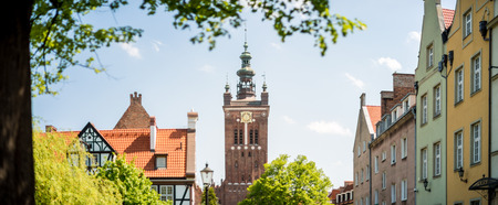 Old houses and tower clock museum panorama of Gdansk, Poland, Europe. Beautiful sunny day, old building. German style in architecture.のeditorial素材