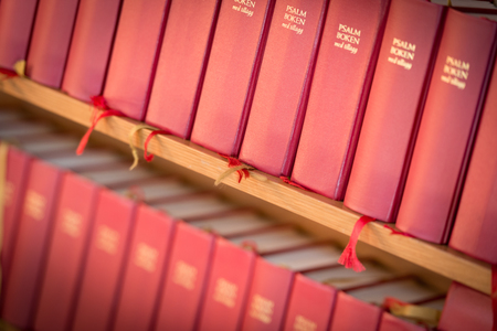 Stack of red bible books in church. Sweden, Scandinavia, Europeの写真素材