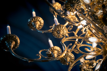 Beautiful golden grand lamp with candles in church. Sweden, Scandinavia, Europe.の写真素材