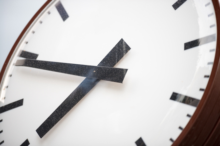 Retro clock with hour and minute hands close-up. Old white dial with black stripes instead of numbers.の写真素材
