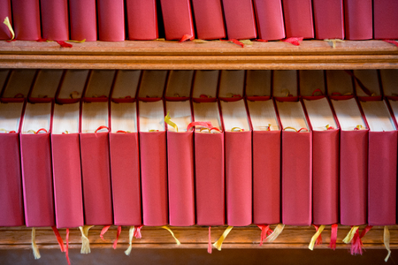 Stack of red bible books in church. Sweden, Scandinavia, Europeの写真素材