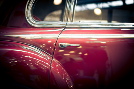 Door and window details of red retro car.の写真素材