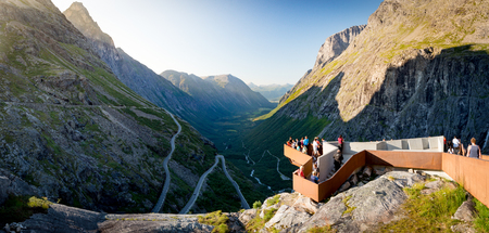 Rauma Municipality, Norway - 25 July, 2013: people on observation deck over Trollstigen mountain road. Serpentine road with cars and mountains in background. Popular tourist destination in Scandinavia, Europe.のeditorial素材