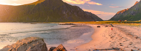 Landscape at sunset with beach and mountains. Purple sky in background. Travel in Norway, Scandinavia, Europe.の写真素材