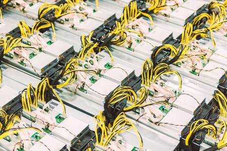 Rows of dedicated ASIC for cryptocurrency mining farm. Bitcoin, Ethereum and other altcoins producing rig.の写真素材