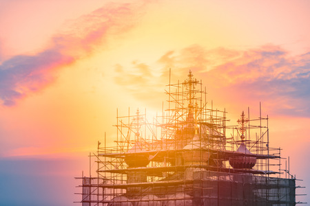 Church restoration in Russia at sunset. Orange cloudy sky in background.の写真素材