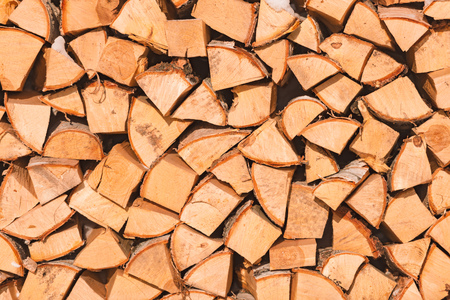 Stack of wood logs. Preparation of firewood for the winter. Pile of chopped lumber.の写真素材