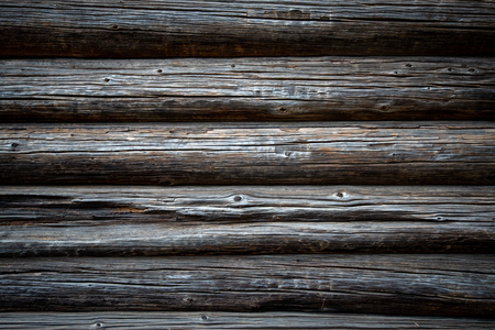 Old wood log background with cracks and lines. Light in the middle with space for copy, dark at the sides. Wall of house.の写真素材