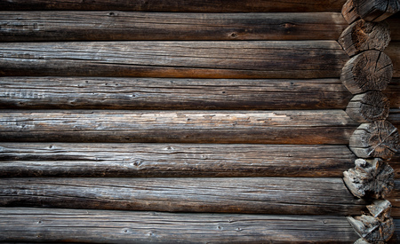Old wood log background with cracks and lines. Light in the middle with space for copy, dark at the sides. Wall of house.の写真素材
