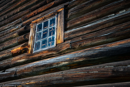 Old wood log background with cracks and lines. Windows on wall of house.の写真素材